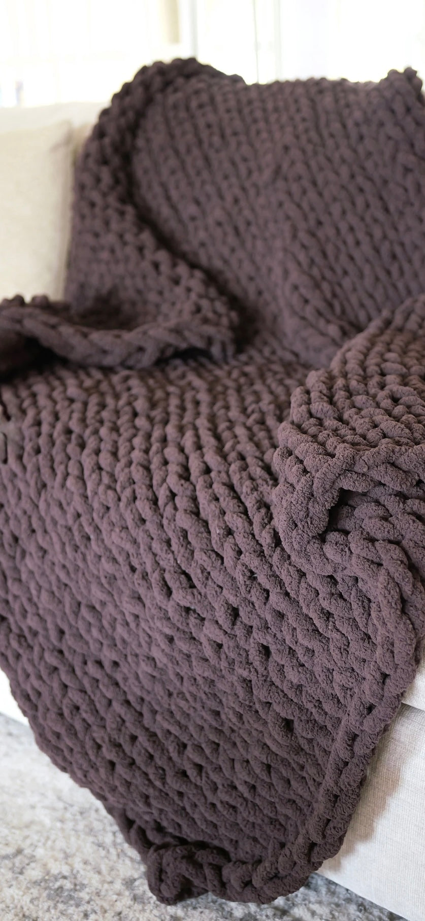 Knitted brown blanket on a white surface